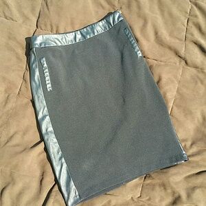 Black skirt with exposed zipper on side.